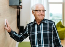 home-automation-elderly-man-pressing-aal-emergency-button