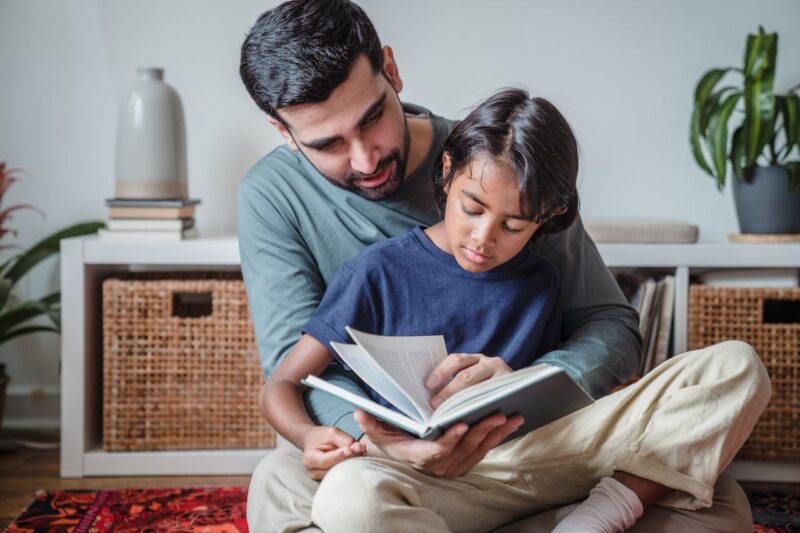 Father and son reading in the living room