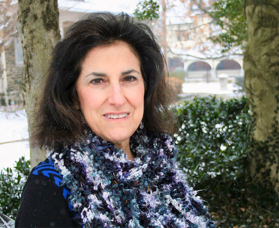 Head shot of Abby Schwartz with plants in background