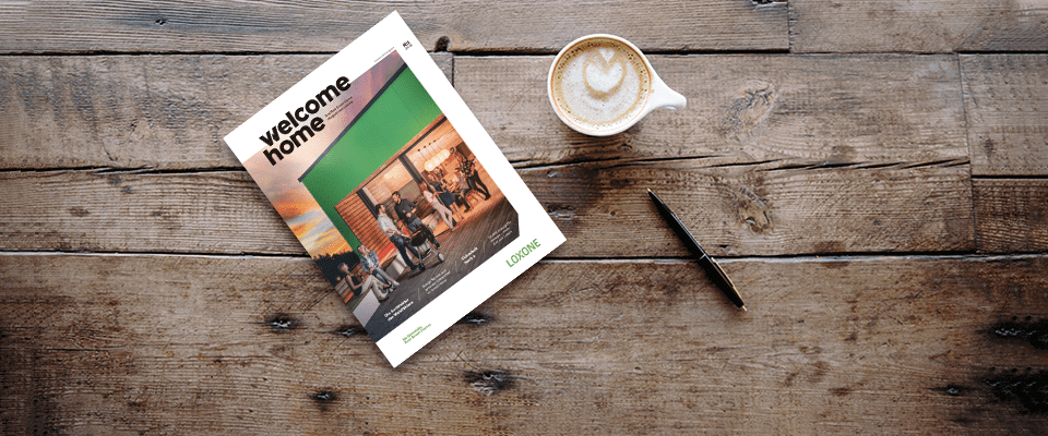 Welcome Home magazine displayed on wood surface with coffee cup