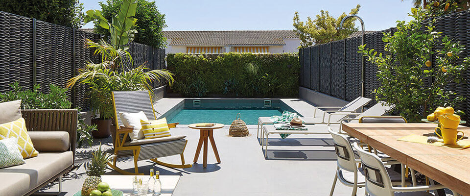 Outdoor living area with pool and plants