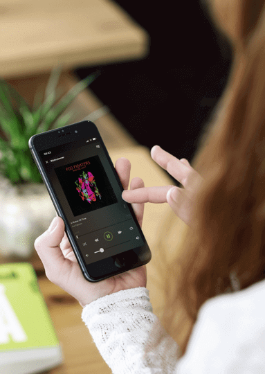 Woman holding smartphone with Loxone app displayed