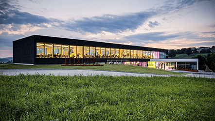 Global headquarters exterior glowing at dusk