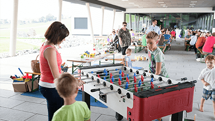 Family playing foosball outside