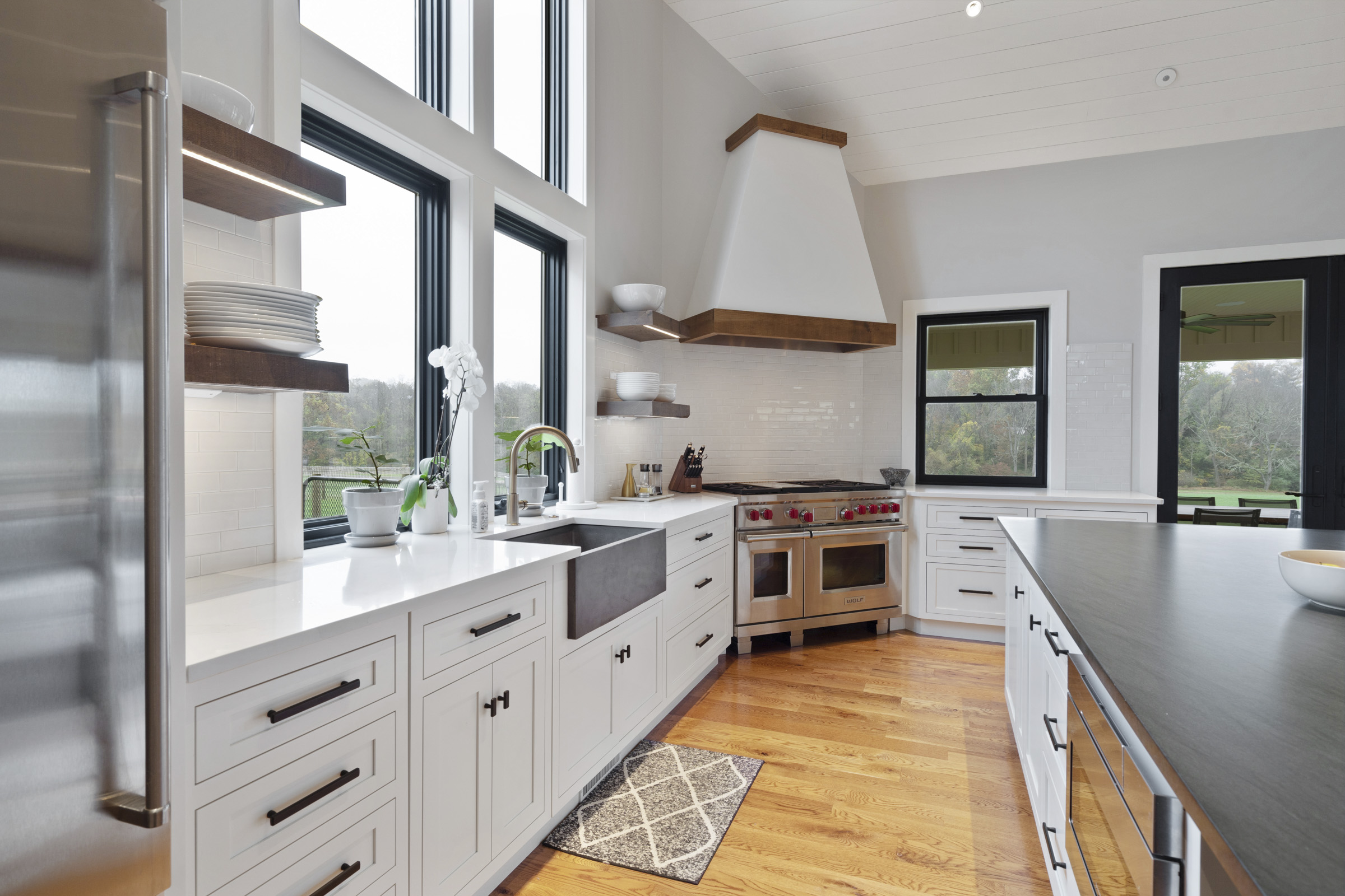 Kitchen with large windows and accent lighting in custom build home