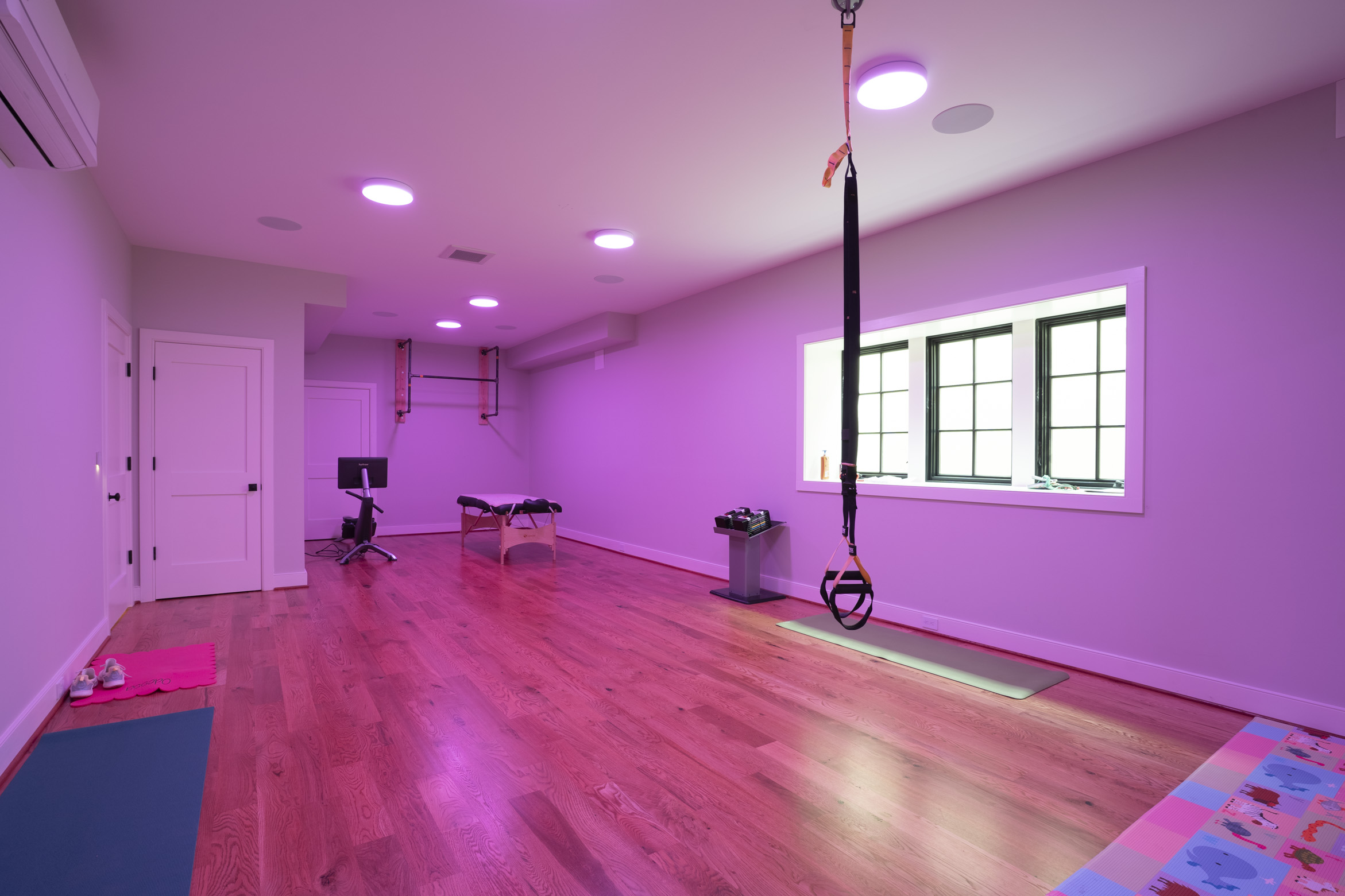 Smart home gym with bright pink lighting