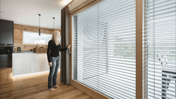 A woman demonstrating residential automated shades