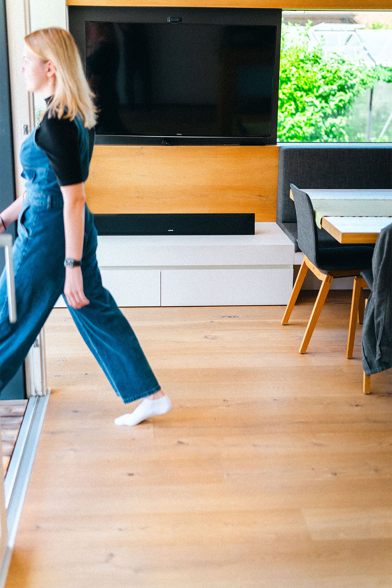 LOXONE Soundbar beneath a wall-mounted TV in a bright, modern living room