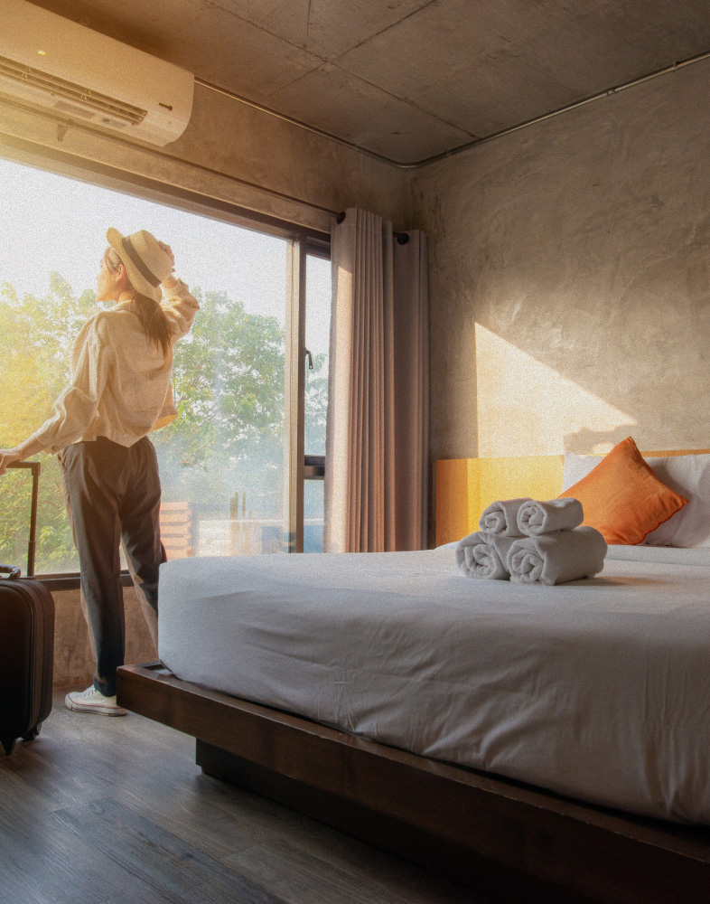 A woman enjoying a hotel room with perfect room climate