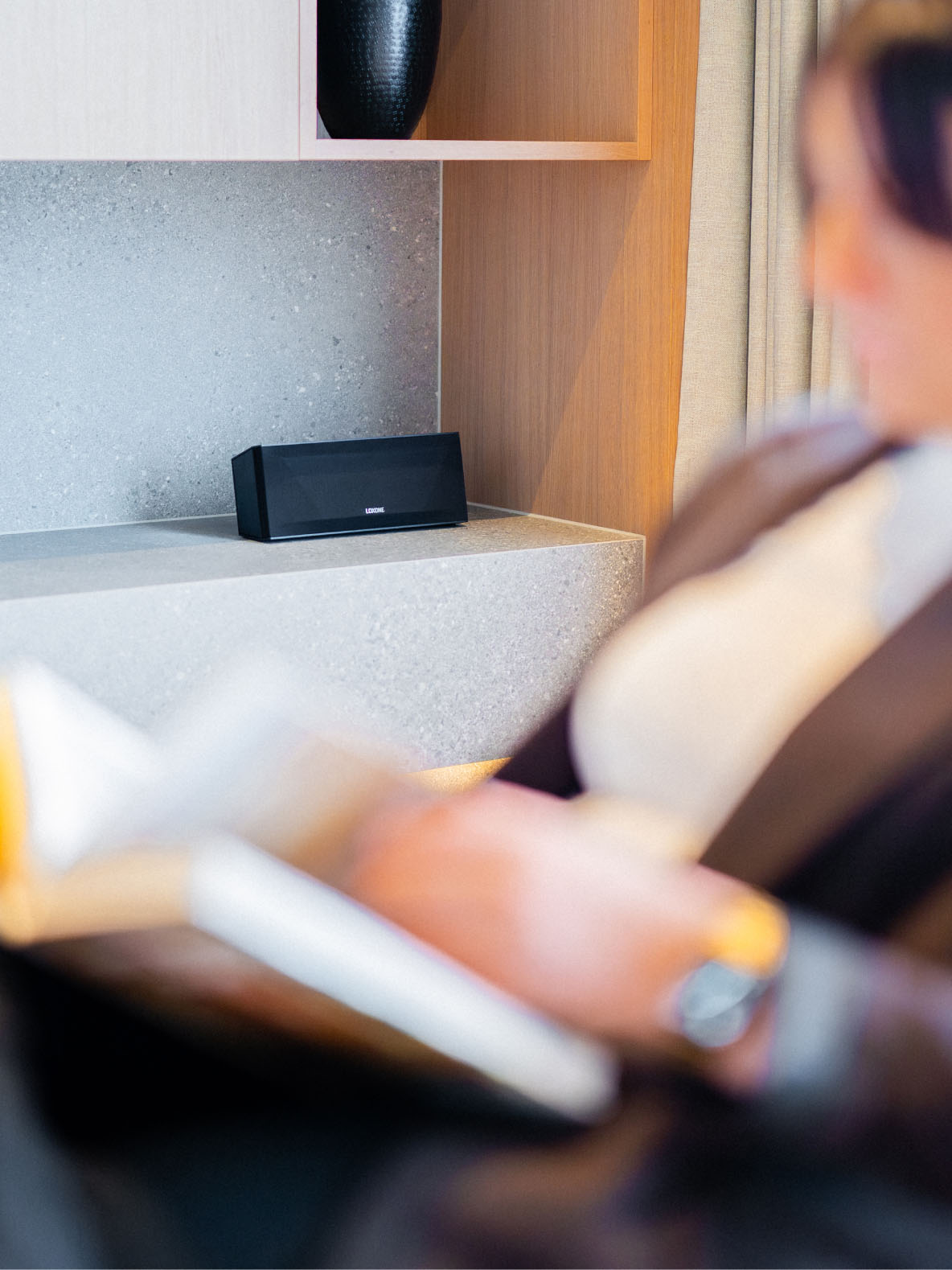 Žena si číta knihu pri prehrávaní ambientnej hudby z Wireless Speakeru