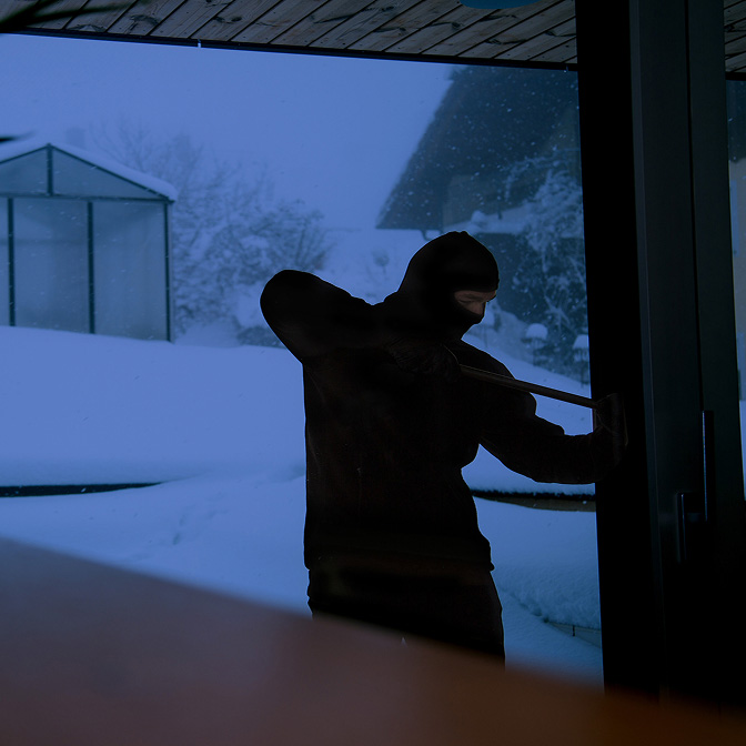 Грабіжник намагається потрапити до будівлі.